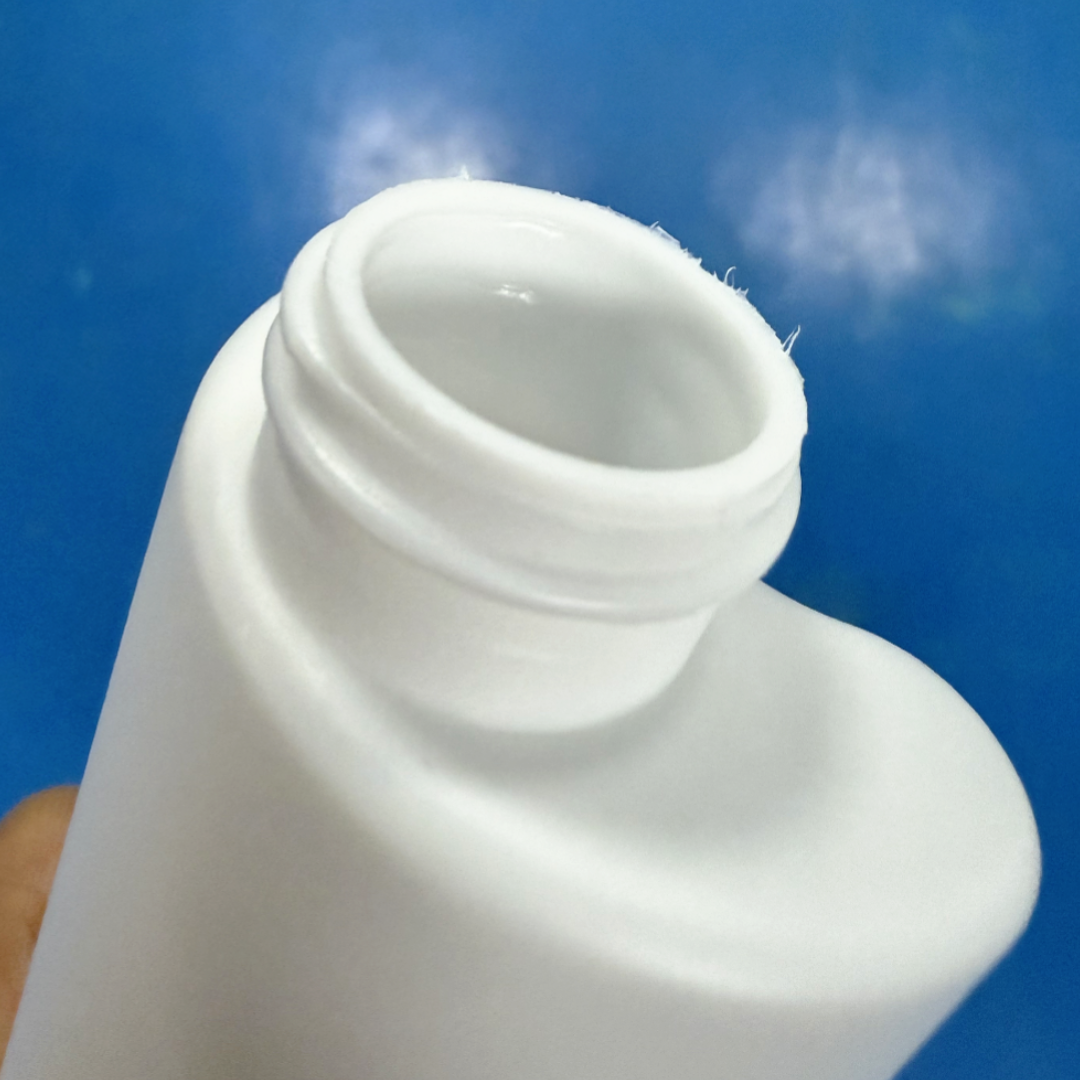Bottle neck with heavy flash and a rough thread, before trimming