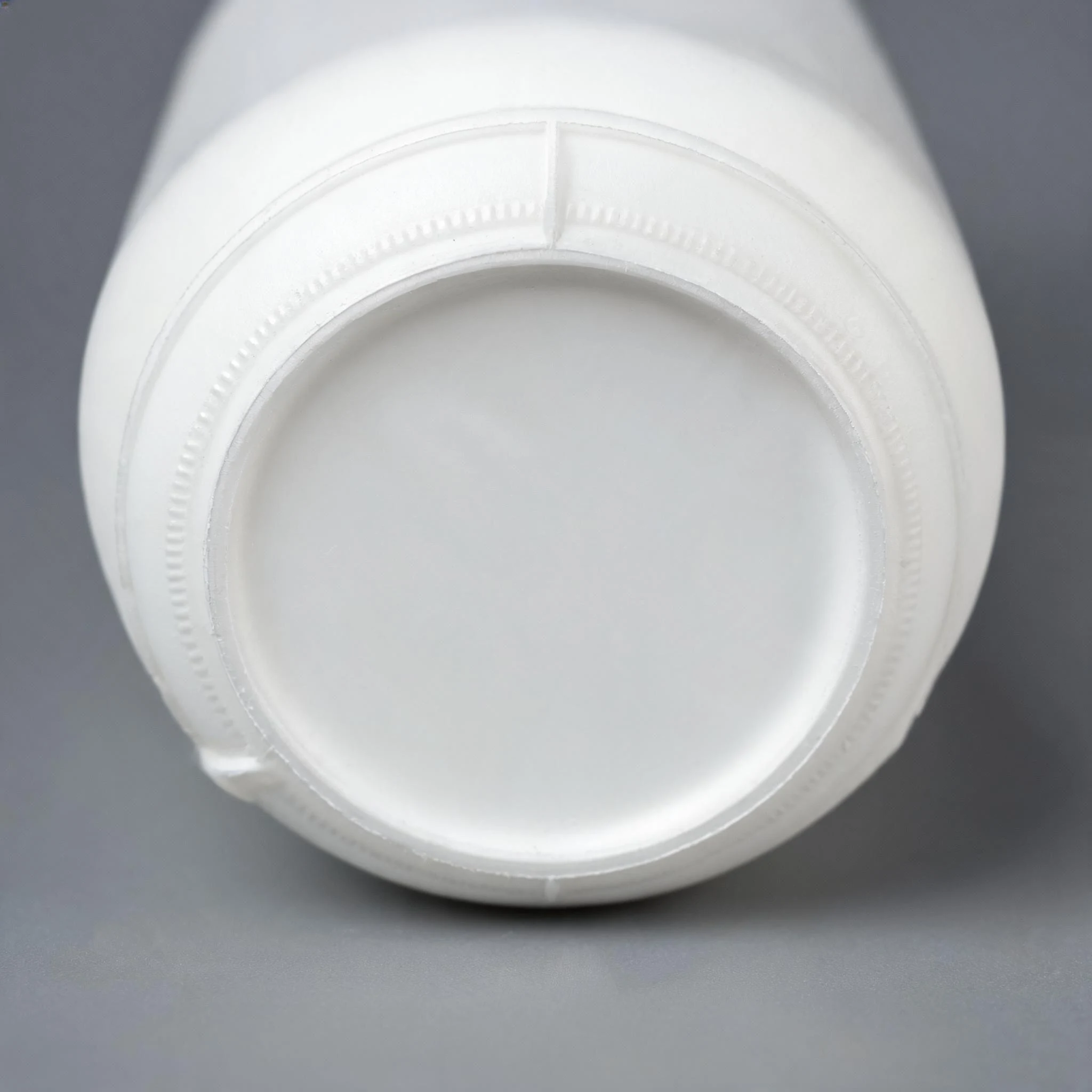 Cleanly trimmed base ring on a white extrusion blow moulded bottle